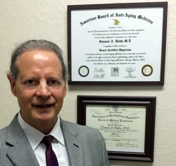 Dr. Botta standing beside professional certificates